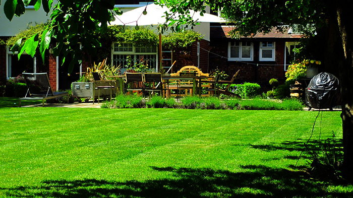 freshly cut lawn mowing with stripes, a summer garden ready to go and enjoy anytime you like